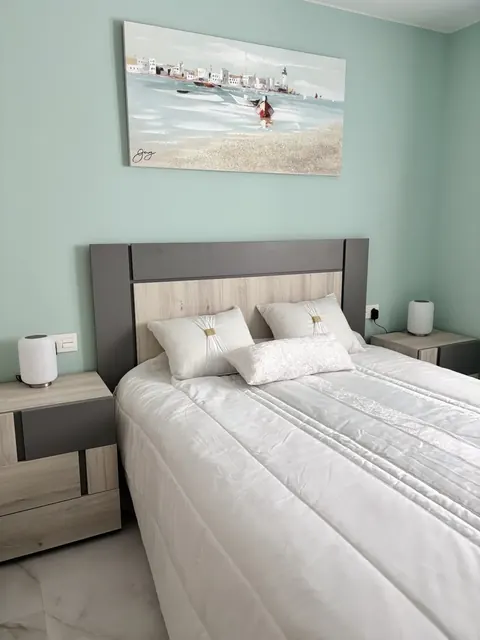 Freshly made bed in a prepared holiday home